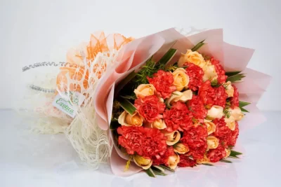 Hand Bunches Orange Carnations & Peach Roses