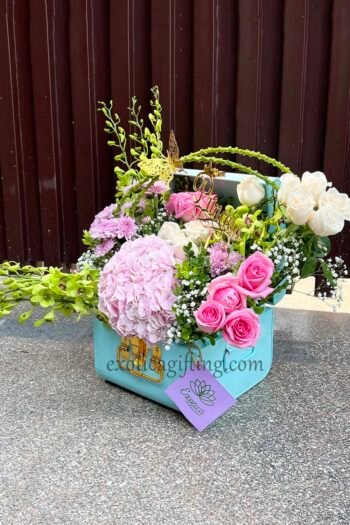 Fresh Flowers Blue Metal Trunk Arrangement of Revival Roses, White Roses & Green Orchids With Hydrangea